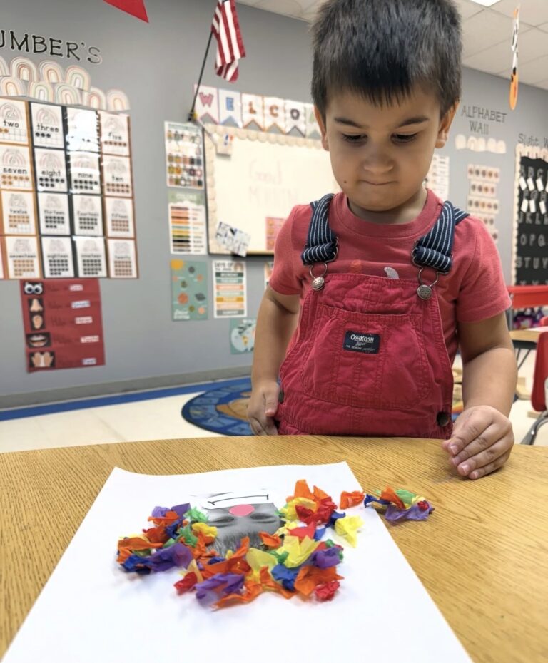 A child creating a colorful paper collage